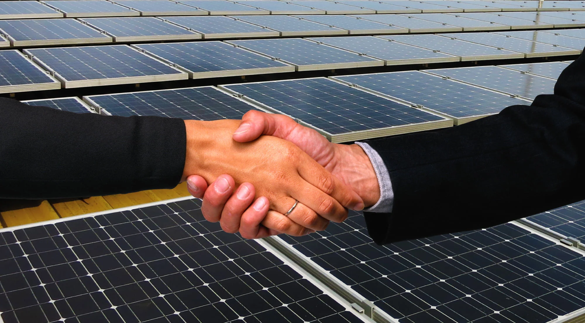 two people shaking hands and PROINSO solar panels in the background